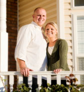 Couple standing in front of new home